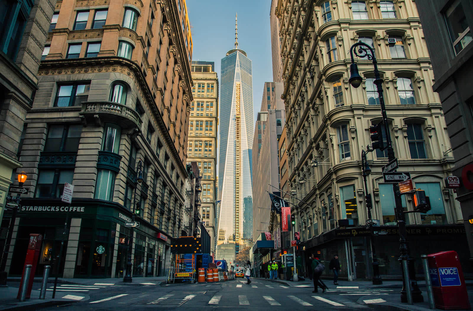 New York City streets with large buildings on each side and looking straight into new World Trade Center Building